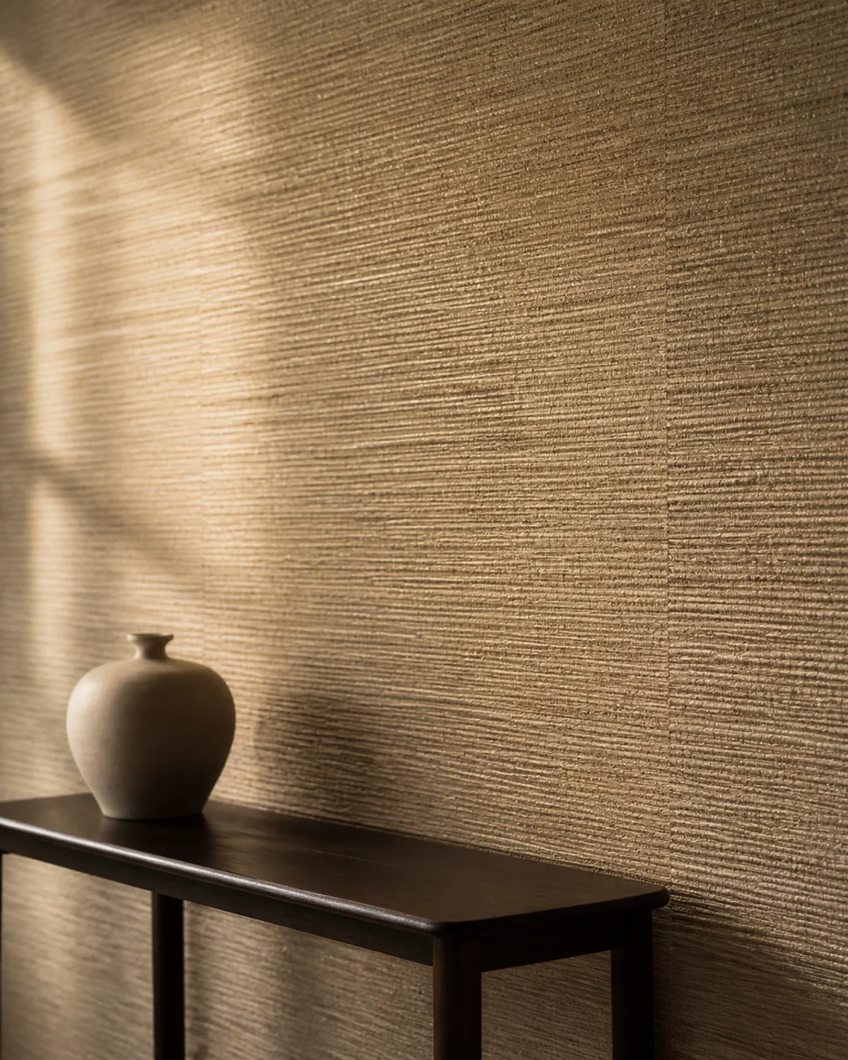 Warm textured grasscloth wallcovering in grazing light