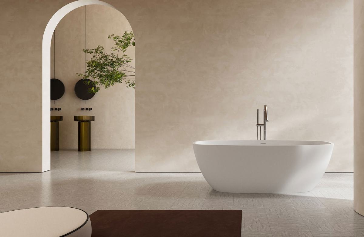 White freestanding bath against a warm plaster arch