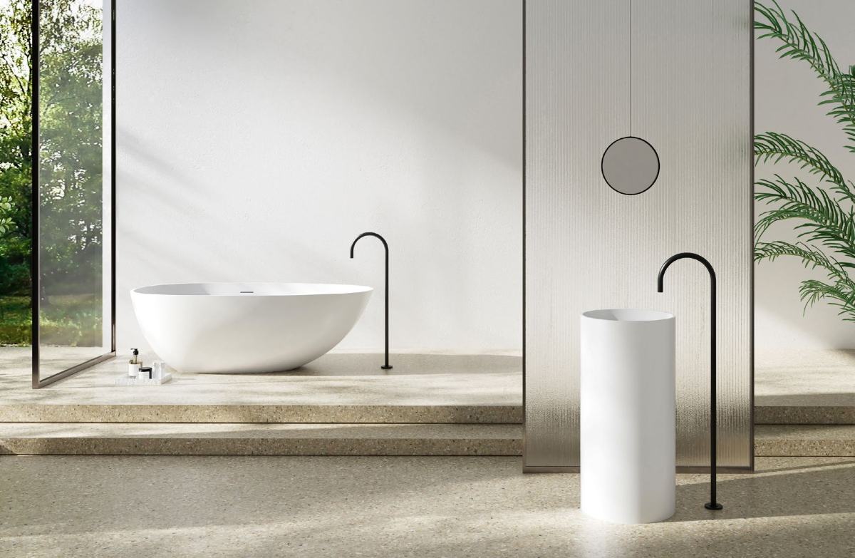 Freestanding solid surface bath and pedestal basin in a terrazzo bathroom